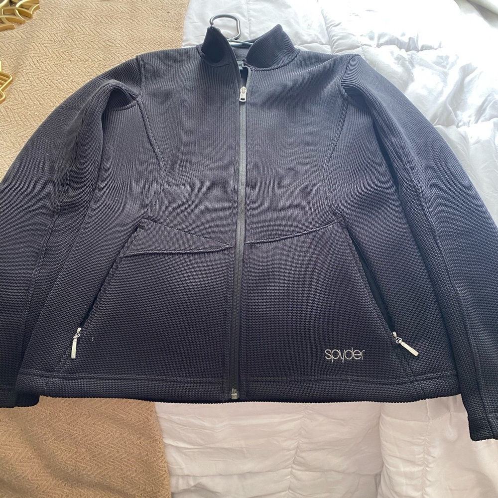 Spyder coat has a small snag on the left arm which is shown in the picture .